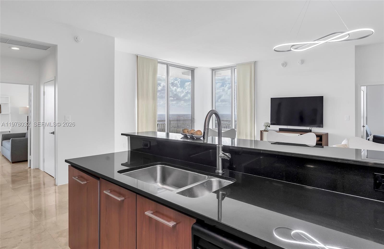 9066 Southwest 73rd Court, Unit PH2402 Miami, FL 33156 - Photo 2 of 45 a kitchen with a sink and a wooden floor