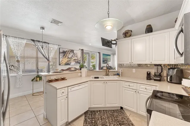 a kitchen with a sink stove and cabinets