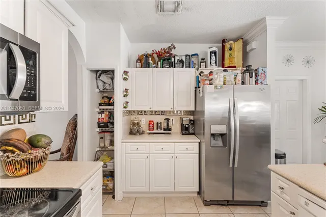 a kitchen with stainless steel appliances a refrigerator sink and cabinets