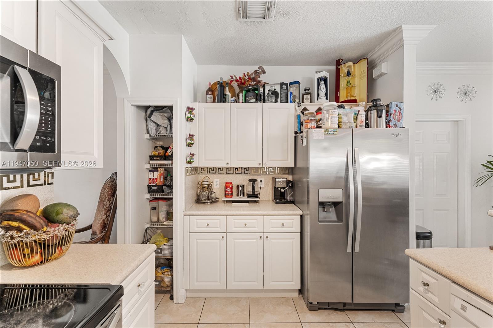 20032 Southwest 128th Court Miami, FL 33177 - Photo 13 of 28 a kitchen with stainless steel appliances a refrigerator sink and cabinets