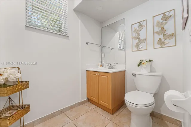 a bathroom with a toilet a sink and a mirror