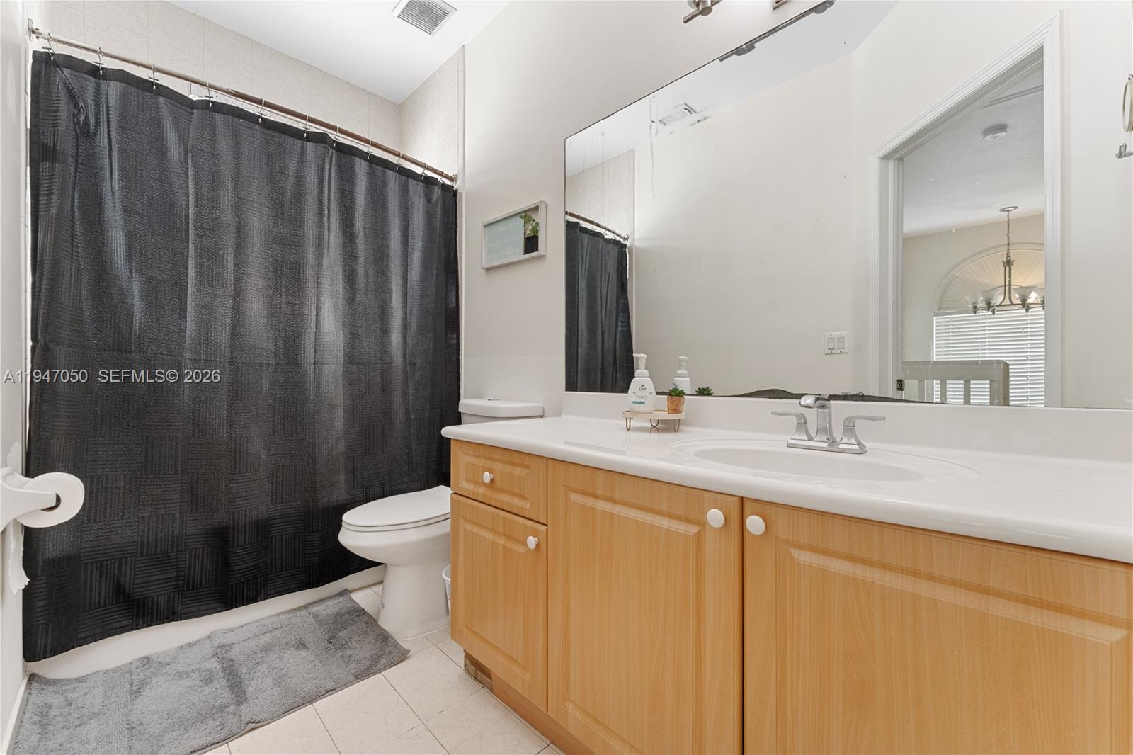 20032 Southwest 128th Court Miami, FL 33177 - Photo 15 of 28 a bathroom with a sink a toilet a mirror and shower