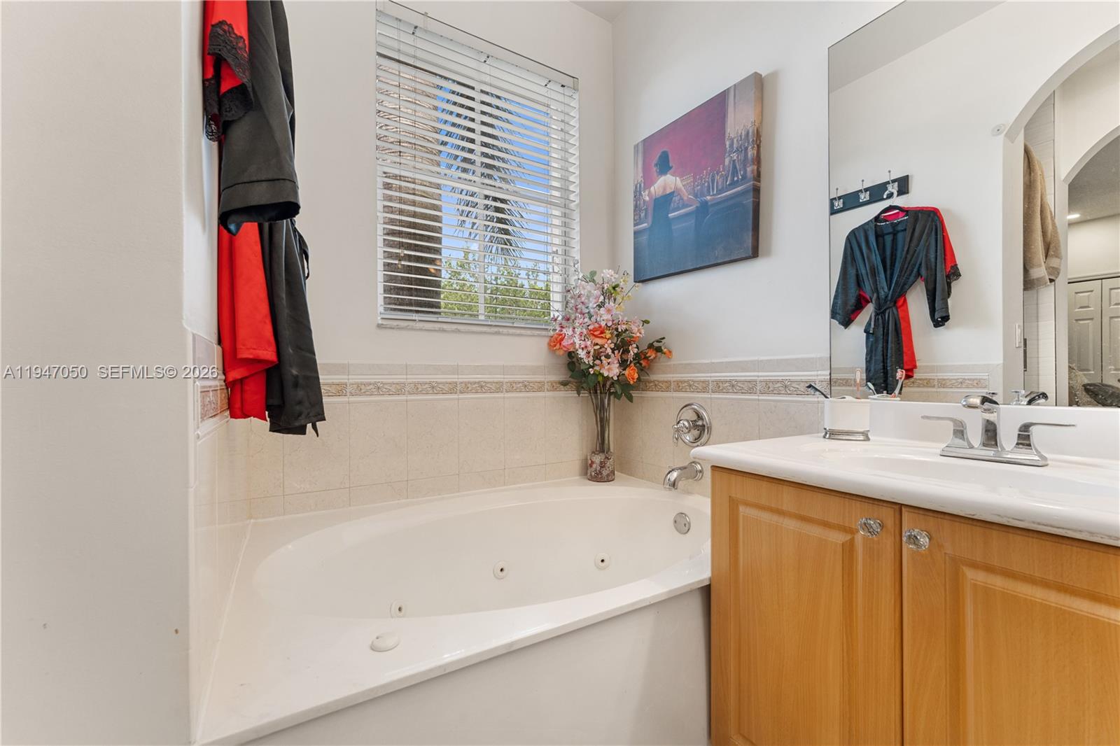 20032 Southwest 128th Court Miami, FL 33177 - Photo 23 of 28 a bathroom with a tub sink and a mirror