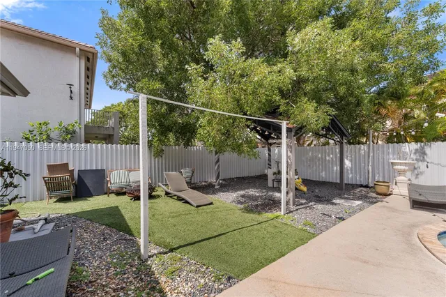 a backyard of a house with table and chairs