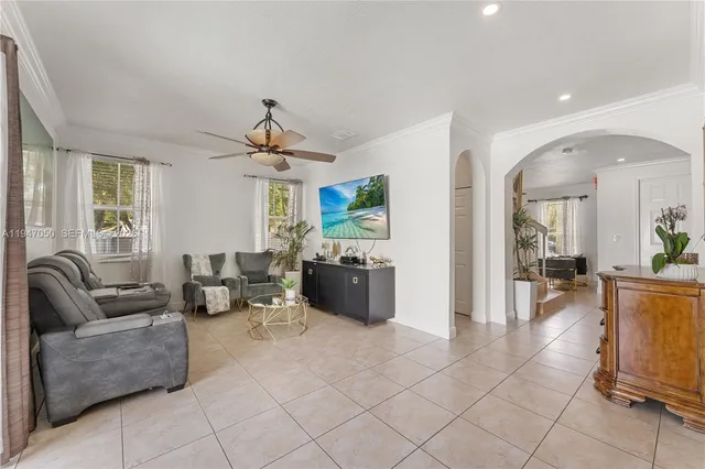 a living room with furniture and a chandelier