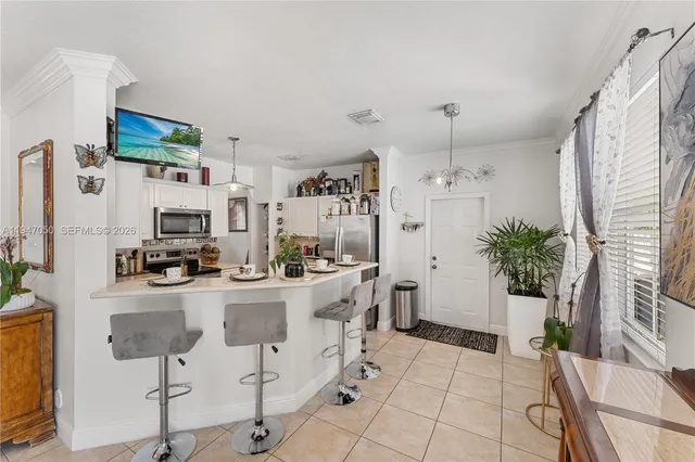 a kitchen with stainless steel appliances kitchen island granite countertop a refrigerator and a stove