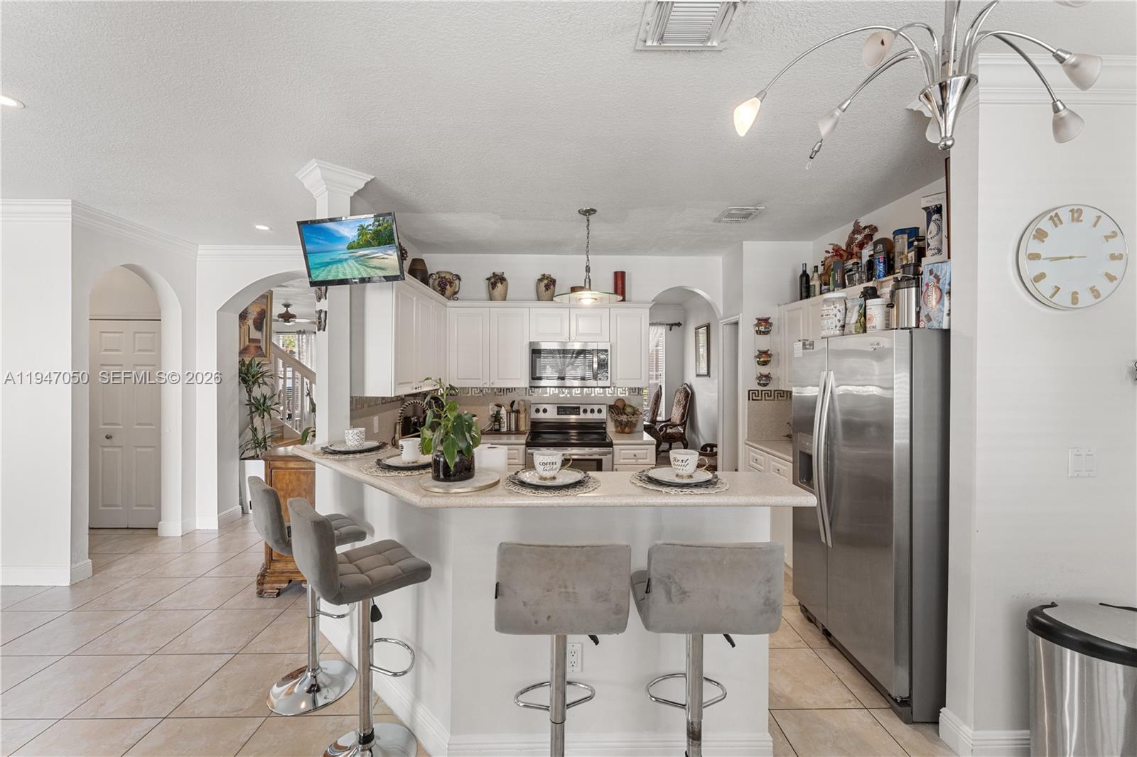 20032 Southwest 128th Court Miami, FL 33177 - Photo 10 of 28 a kitchen with stainless steel appliances kitchen island granite countertop a refrigerator and microwave