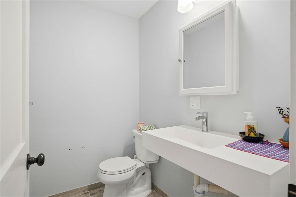 27 Pine Street, Unit 27 Dedham, MA 02026 - Photo 14 of 35 a bathroom with a sink and a toilet