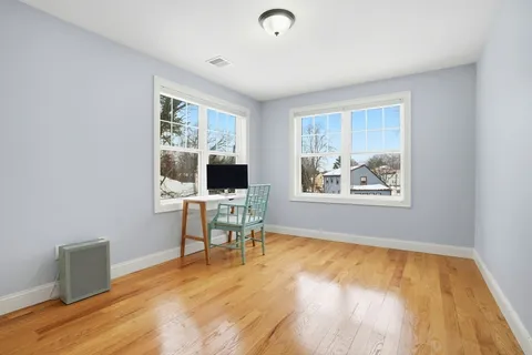 a workspace room with furniture and windows