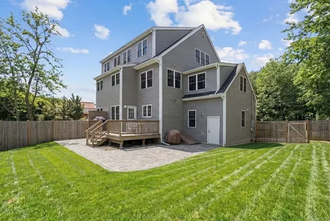 a view of a house with a yard and sitting area