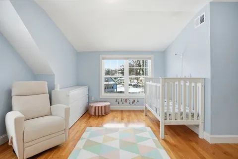 a bedroom with furniture and wooden floor
