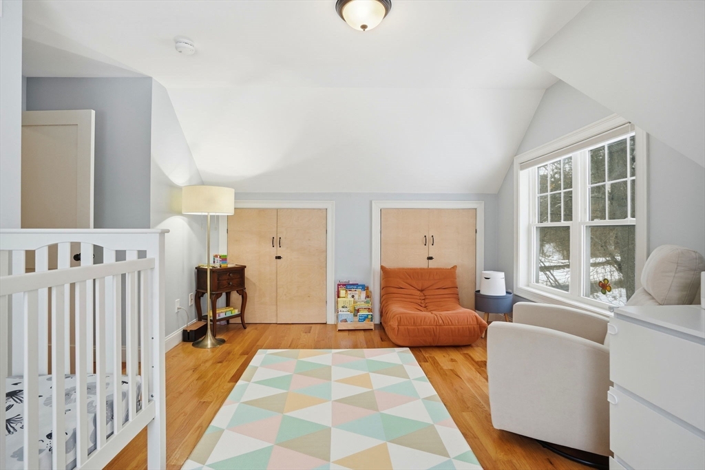 27 Pine Street, Unit 27 Dedham, MA 02026 - Photo 22 of 35 a bedroom with furniture and wooden floor
