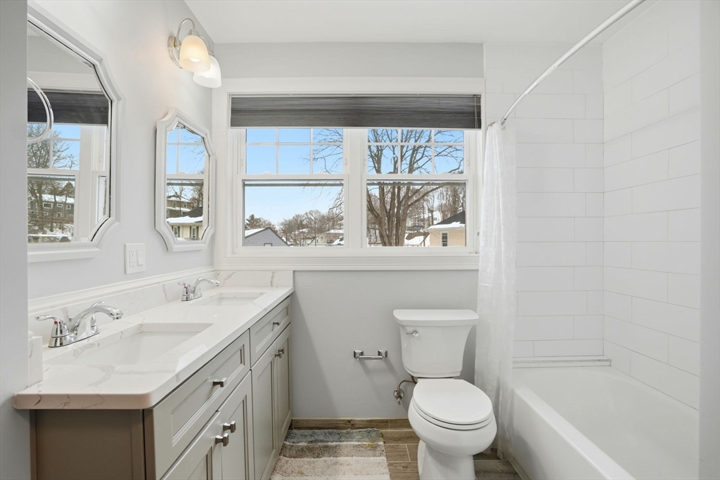 27 Pine Street, Unit 27 Dedham, MA 02026 - Photo 25 of 35 a bathroom with a sink a toilet and a window