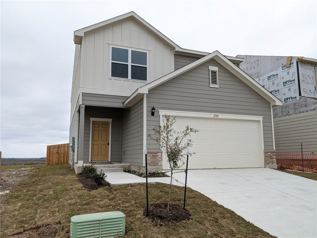 6705 Routenburn Street Austin, TX 78754 - Photo 1 of 18 a front view of a house with garden