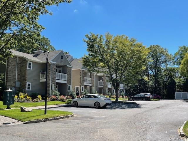 1000 Saddle Rock Road, Unit 1203 Holbrook, NY 11741 - Photo 2 of 12 a view of street with parked cars