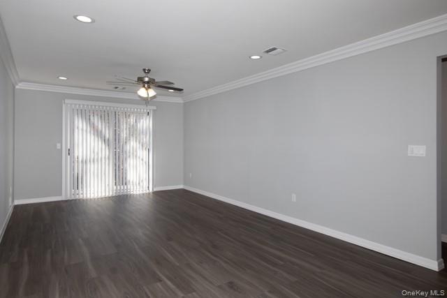 1000 Saddle Rock Road, Unit 1203 Holbrook, NY 11741 - Photo 5 of 12 a view of an empty room with wooden floor and a window
