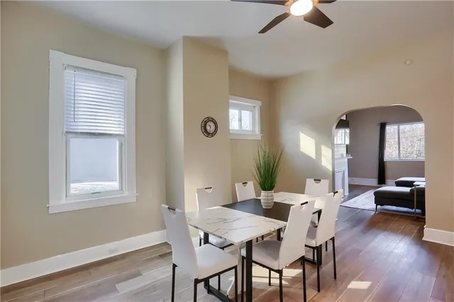 a view of a dining room with furniture and wooden floor