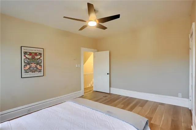 a bedroom with a bed and a ceiling fan