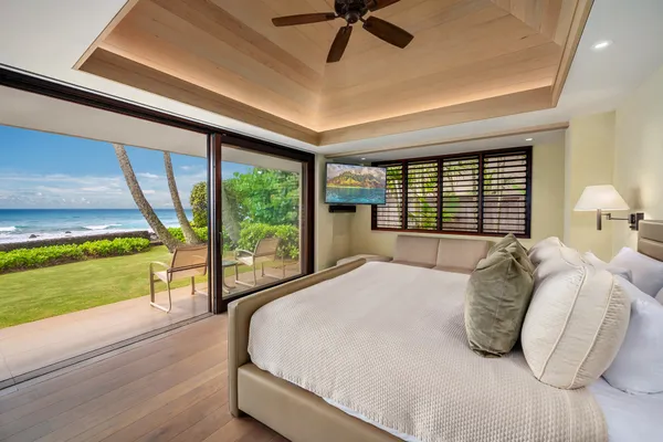 a bedroom with a bed and a large window