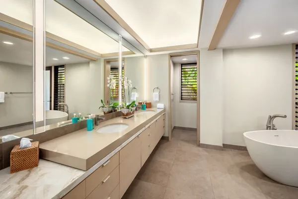 a spacious bathroom with a double vanity sink and a bathtub