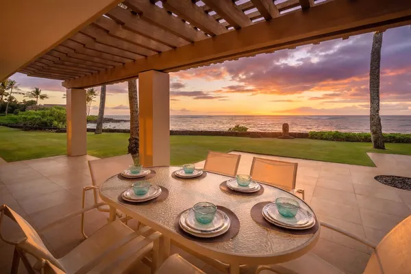a view of a patio with chairs and table in patio