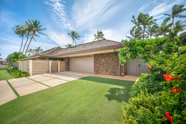 a front view of a house with a yard and a garage