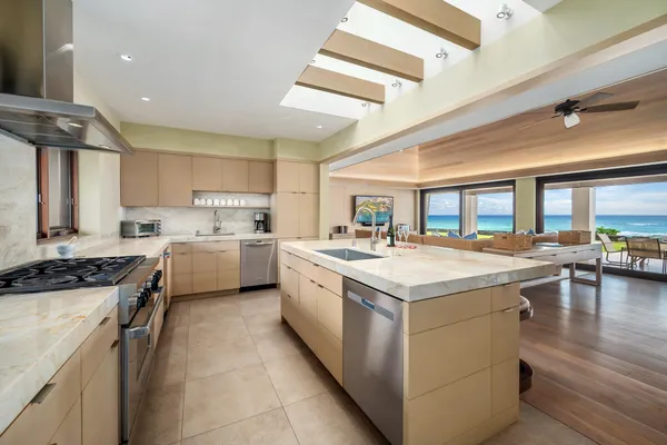 a kitchen with a stove sink and cabinets
