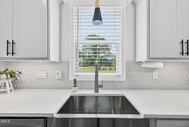 a kitchen with a sink and a window