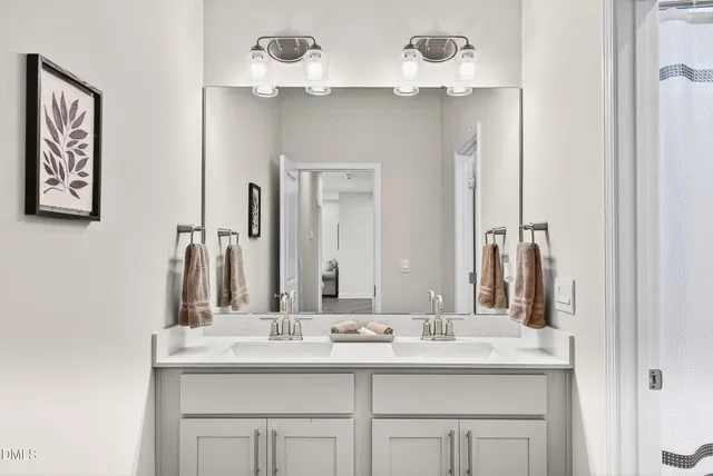 a bathroom with a sink vanity and a mirror