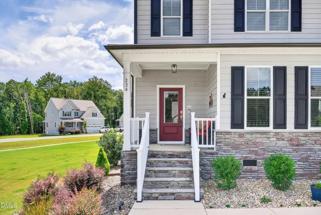a front view of a house with a garden