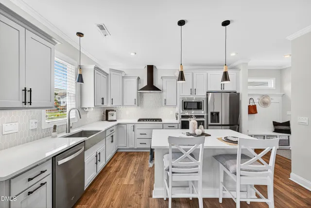 a kitchen with stainless steel appliances kitchen island granite countertop a sink and cabinets