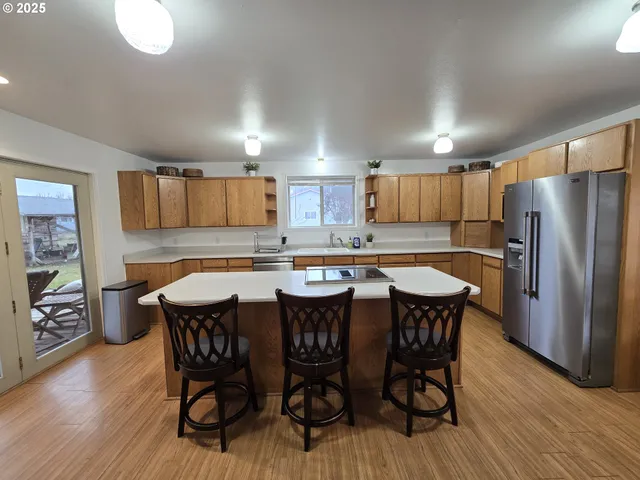 a kitchen with a table chairs refrigerator and microwave