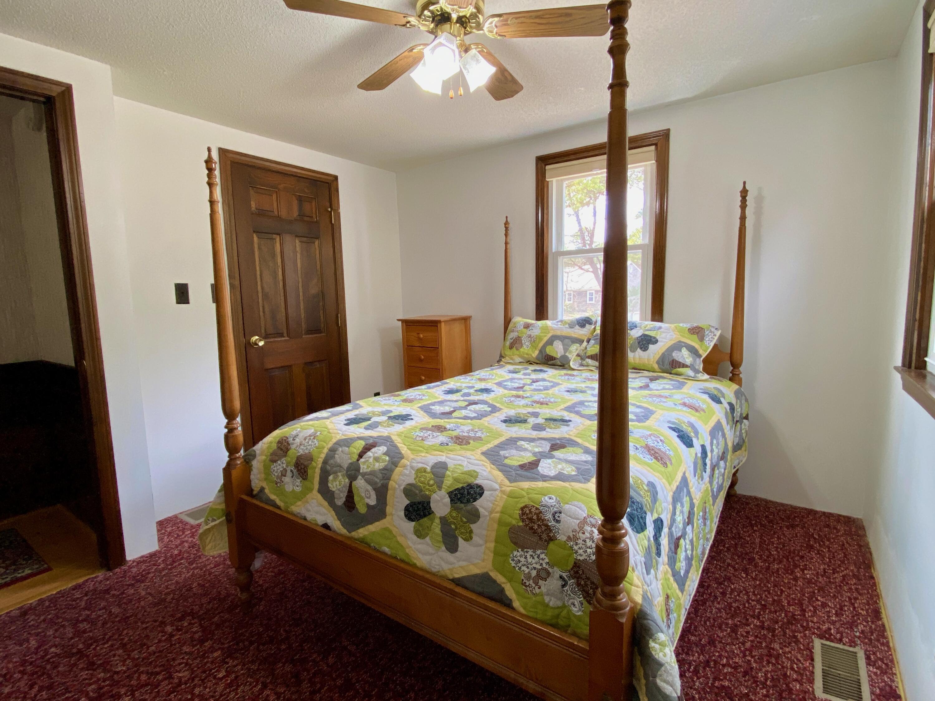 380 Foxwood Drive Eastham, MA 02642 - Photo 13 of 37 a bed sitting in a bedroom next to a window