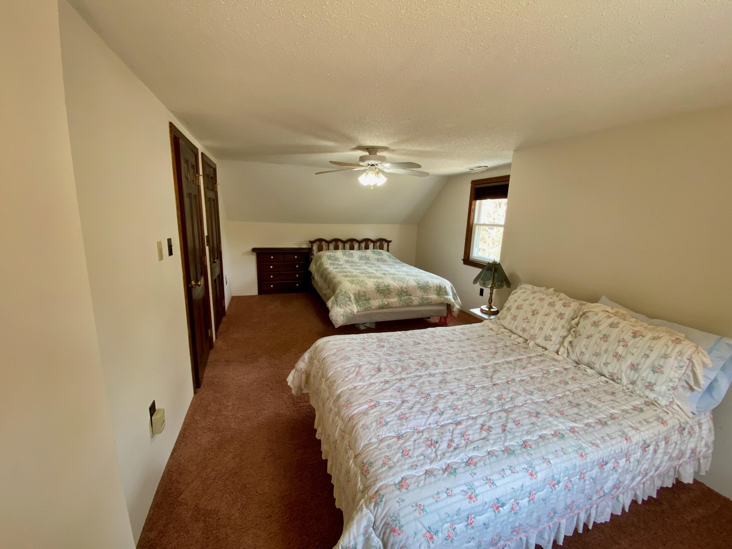 380 Foxwood Drive Eastham, MA 02642 - Photo 18 of 37 a bedroom with a bed and a ceiling fan