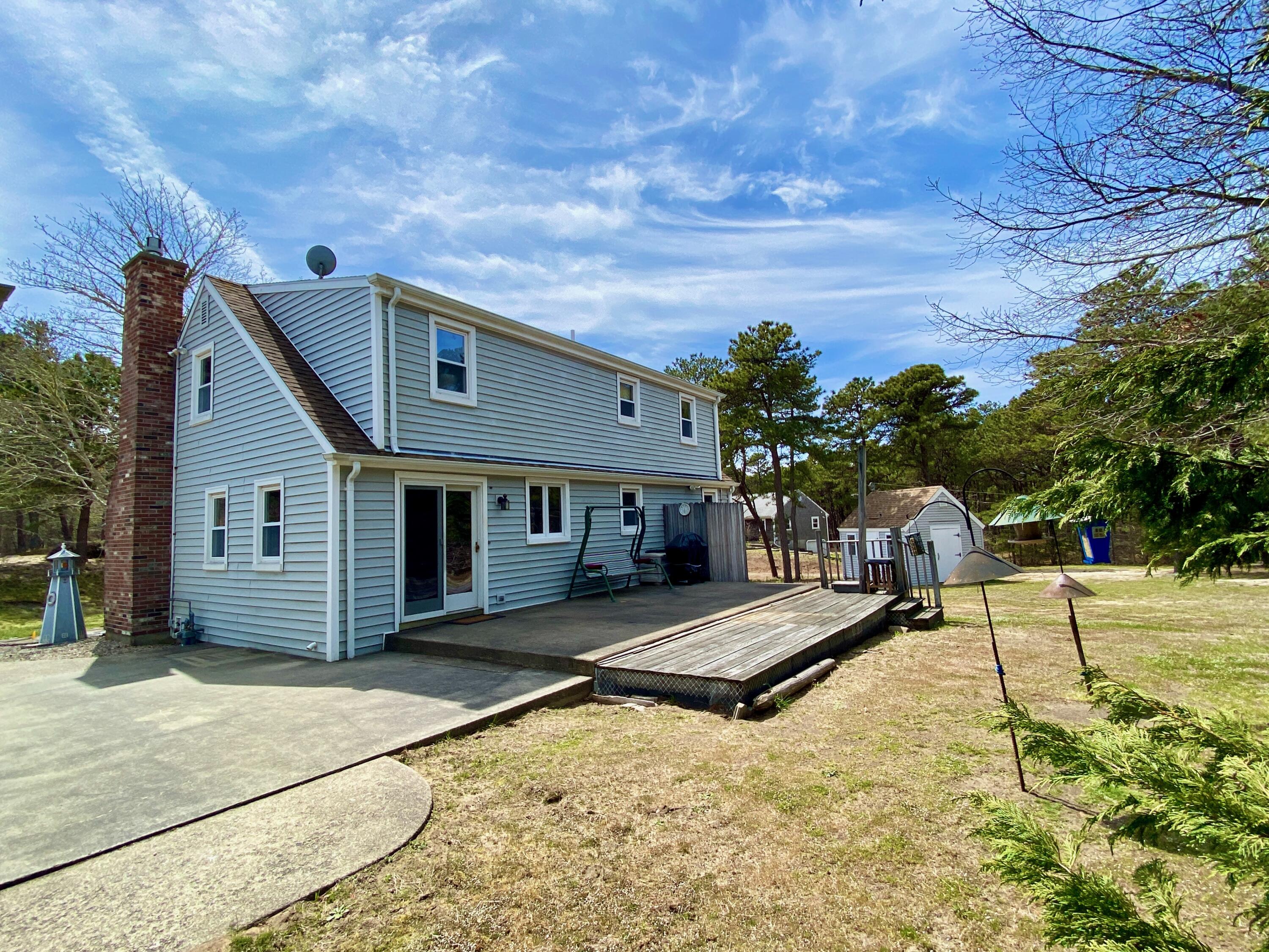 380 Foxwood Drive Eastham, MA 02642 - Photo 3 of 37 a house with trees in the background