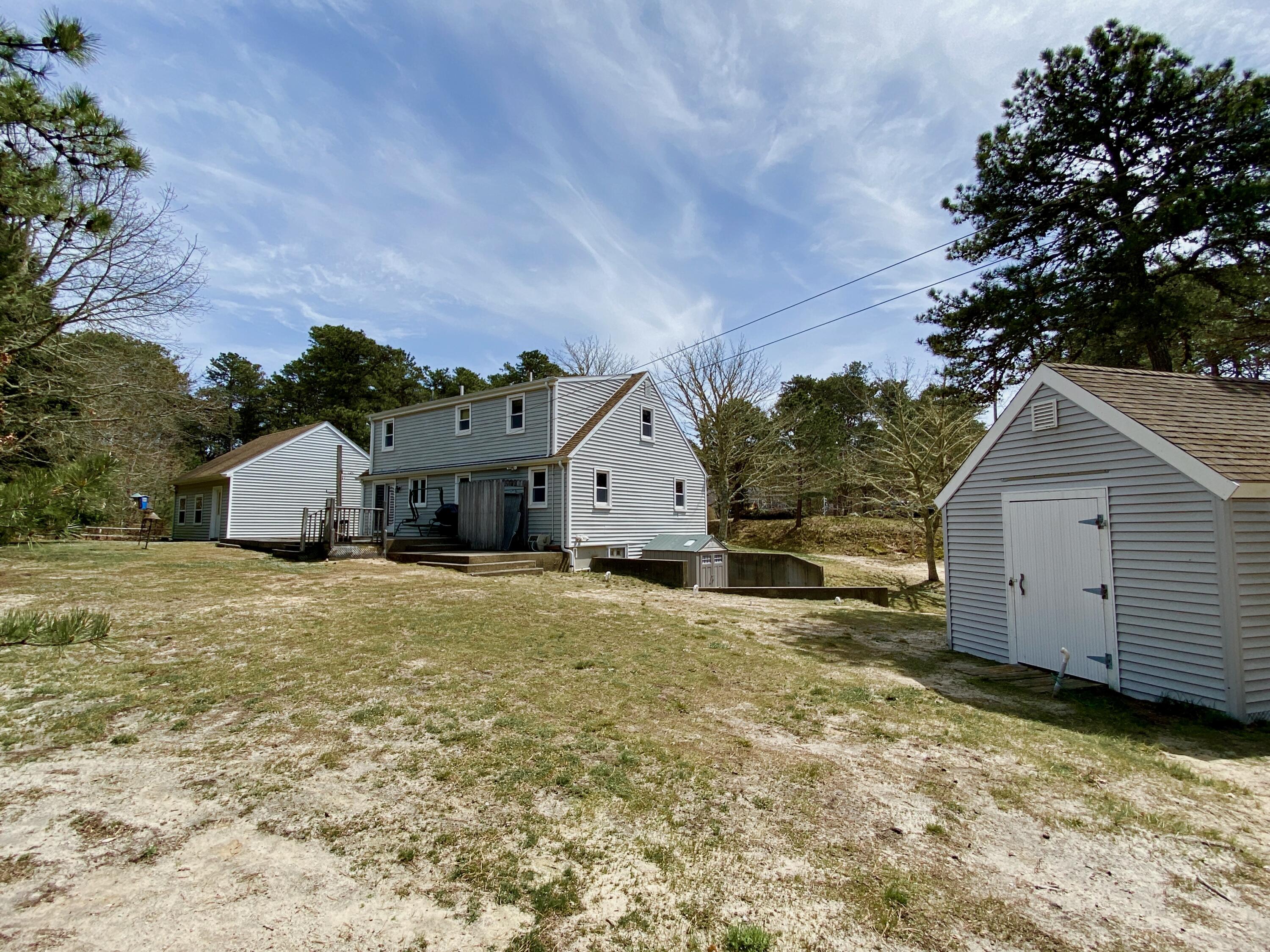 380 Foxwood Drive Eastham, MA 02642 - Photo 32 of 37 a view of a house with a yard