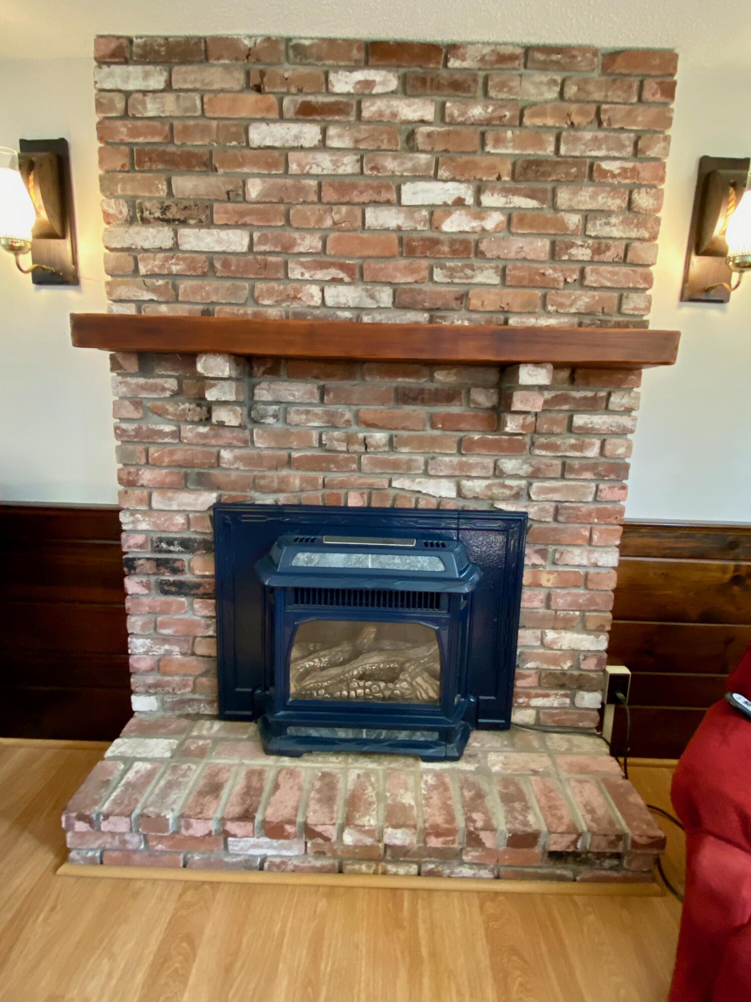 380 Foxwood Drive Eastham, MA 02642 - Photo 6 of 37 a living room with granite countertop a stove a fireplace and a counter top space