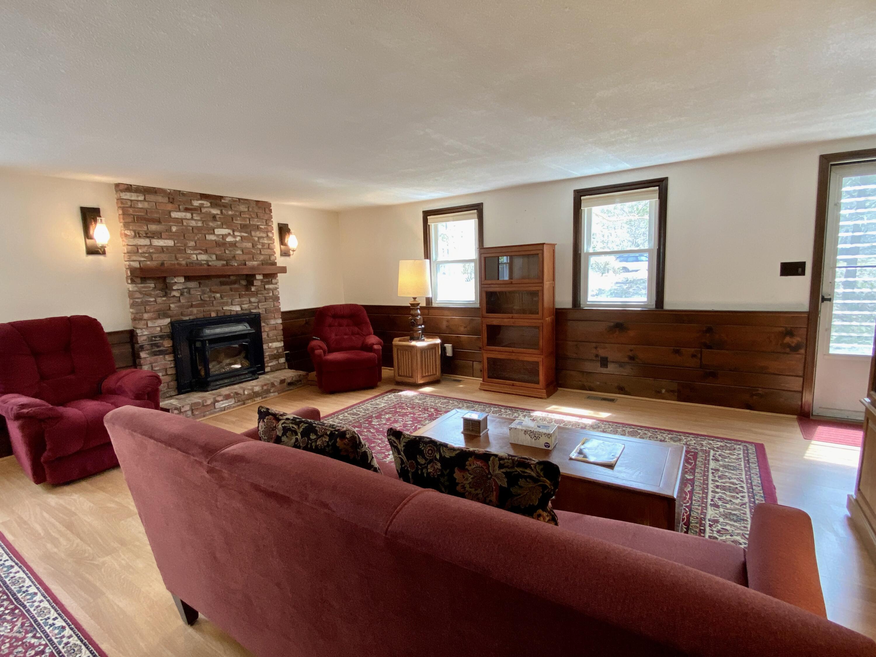 380 Foxwood Drive Eastham, MA 02642 - Photo 8 of 37 a living room with furniture fireplace and a window