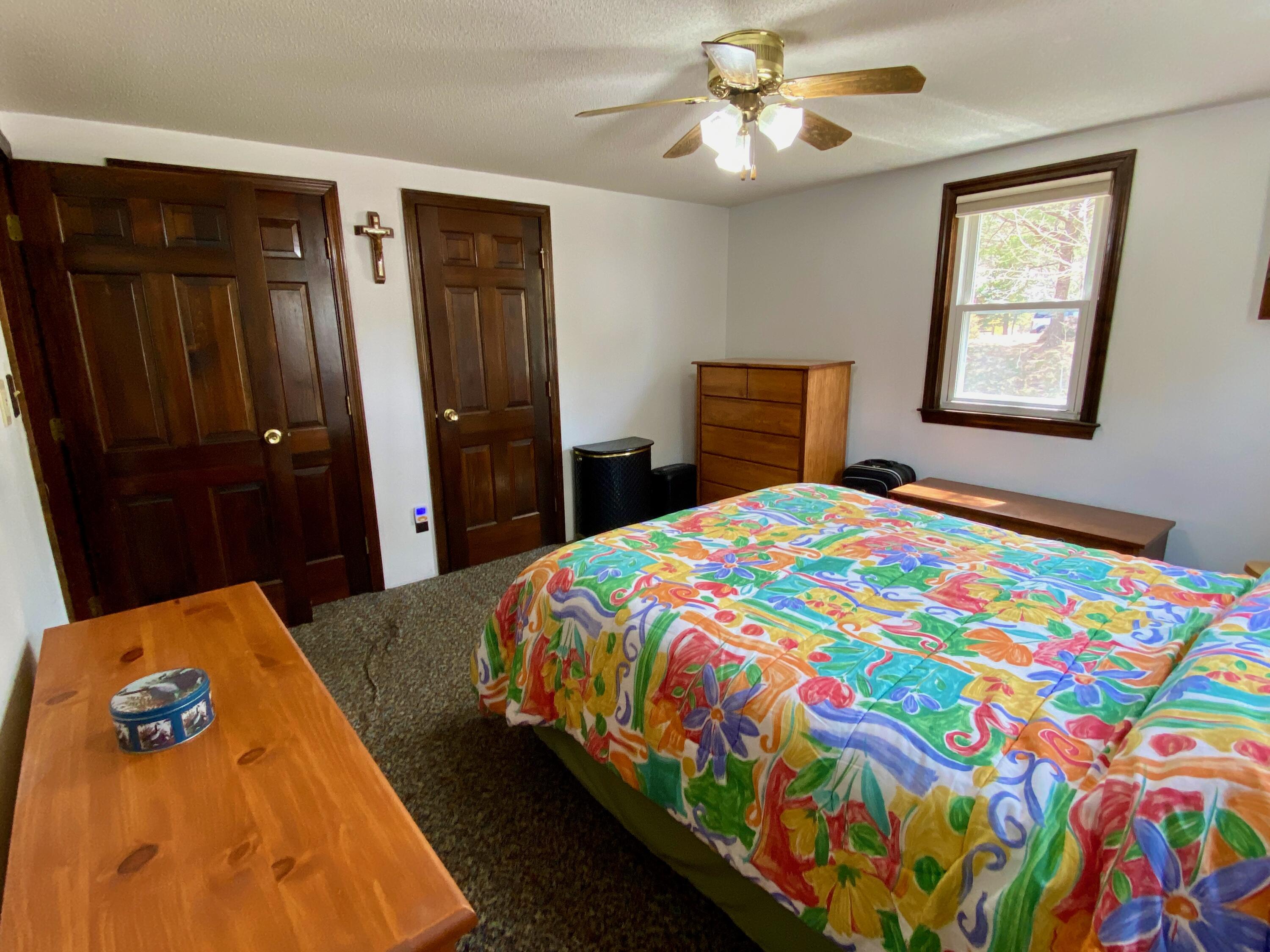 380 Foxwood Drive Eastham, MA 02642 - Photo 10 of 37 a bedroom with a bed and a lamp on dresser