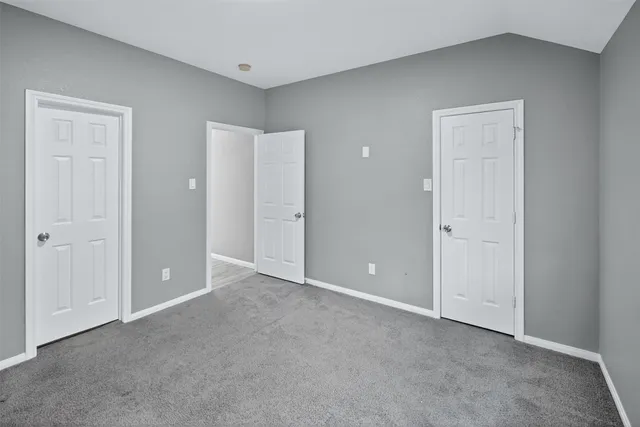 a bathroom with a granite countertop double vanity sink and a mirror