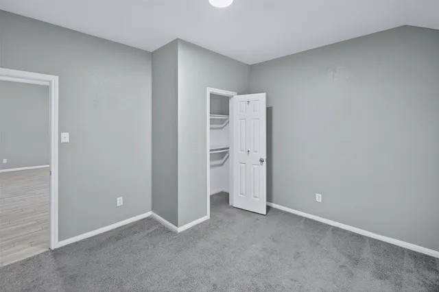 a en suite bathroom with a granite countertop sink and a mirror