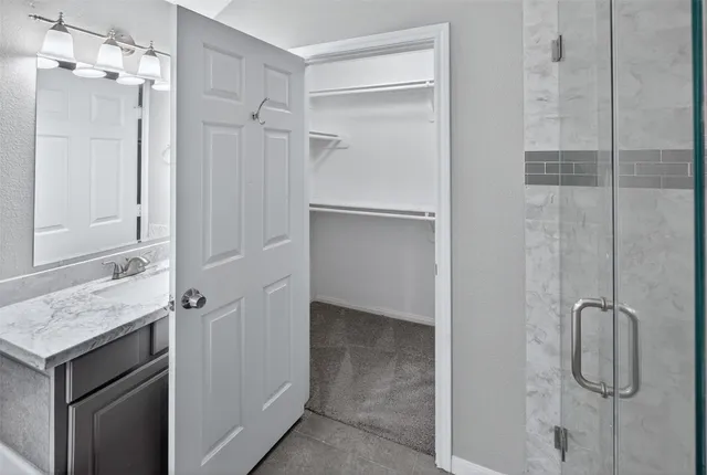 a bathroom with a bathtub sink and mirror