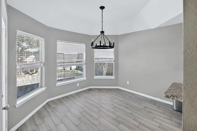 a kitchen with stainless steel appliances granite countertop a stove and refrigerator