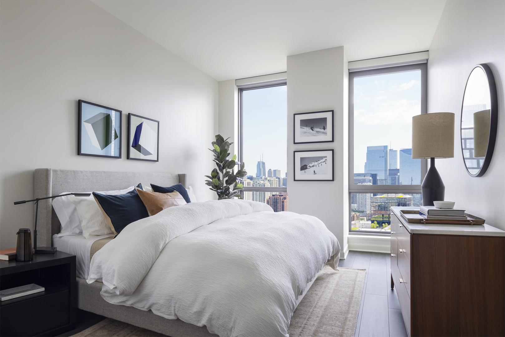 164 North Peoria Street, Unit 2504 Chicago, IL 60607 - Photo 7 of 10 a bedroom with a bed and a lamp with dresser