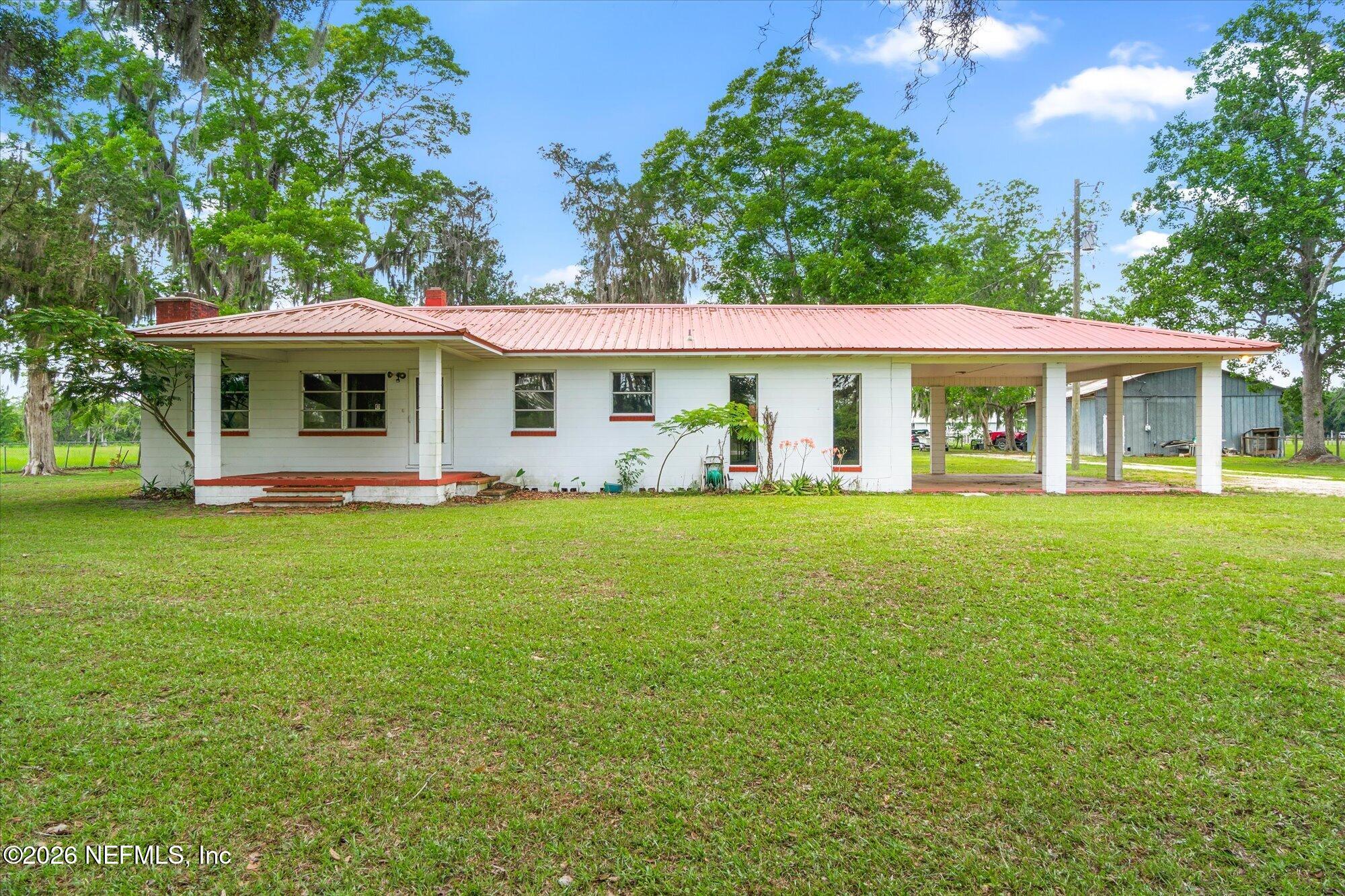786 West River Road Palatka, FL 32177 - Photo 1 of 53 a front view of house with outdoor seating and green space