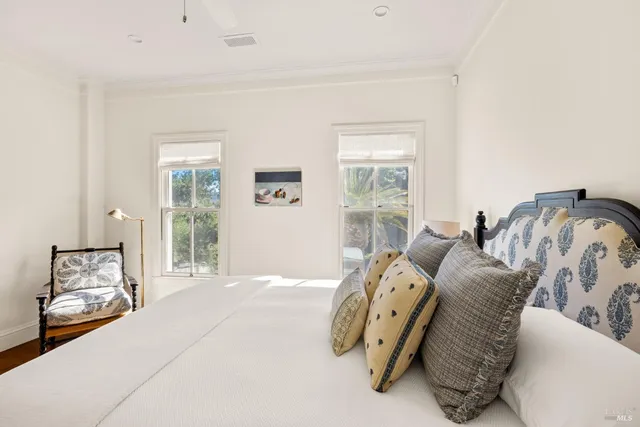 a bedroom with a bed and hallway