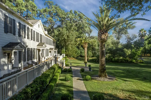 a living room with furniture a fireplace and a large window