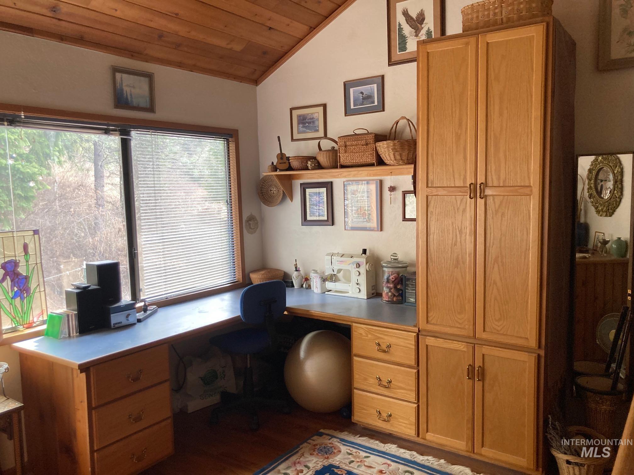 266 Falcon Ridge Road Kooskia, ID 83539 - Photo 17 of 50 Spacious room featuring a prominent L-shaped desk with integrated storage drawers