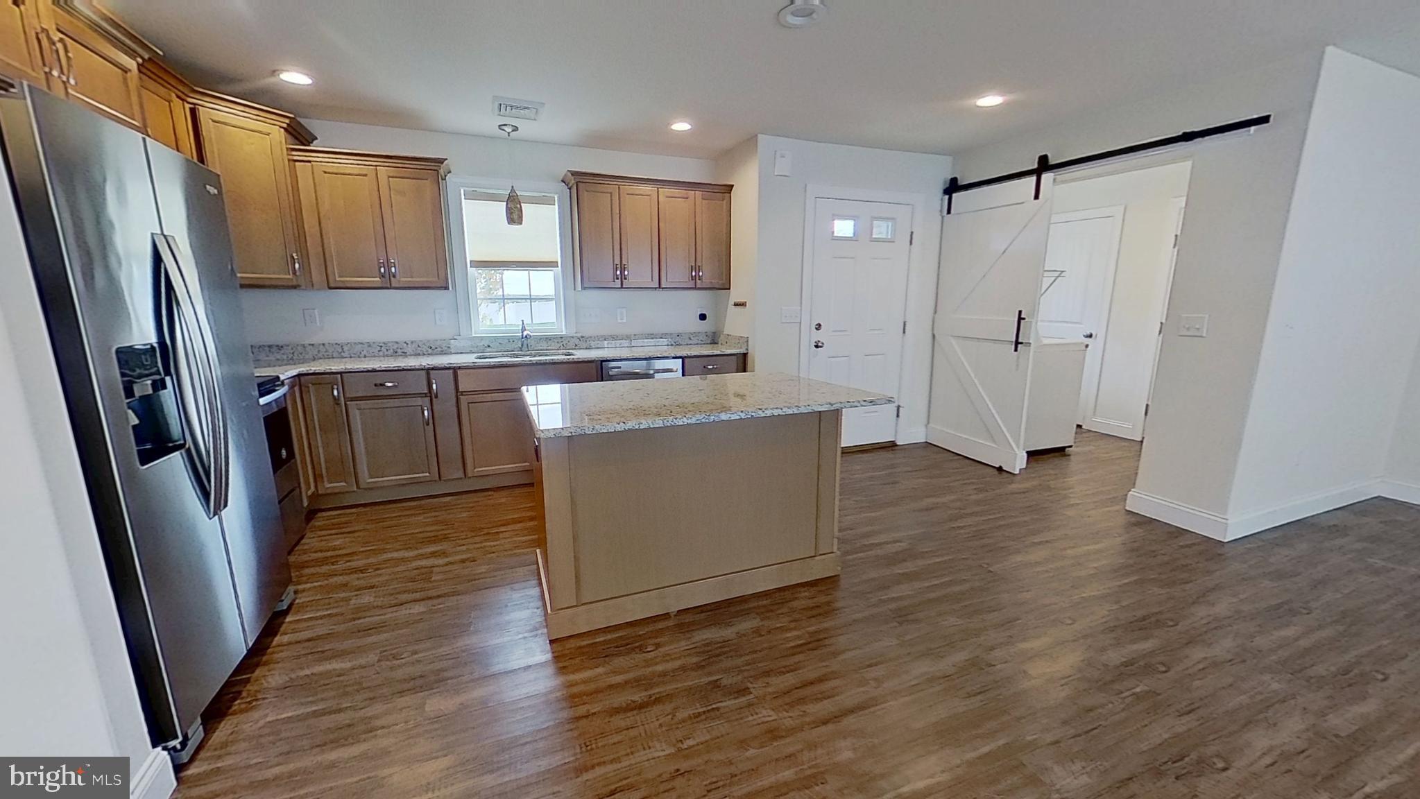 10 Evan Drive York, PA 17404 - Photo 4 of 11 a kitchen with stainless steel appliances granite countertop a refrigerator a sink a stove a microwave and wooden floor