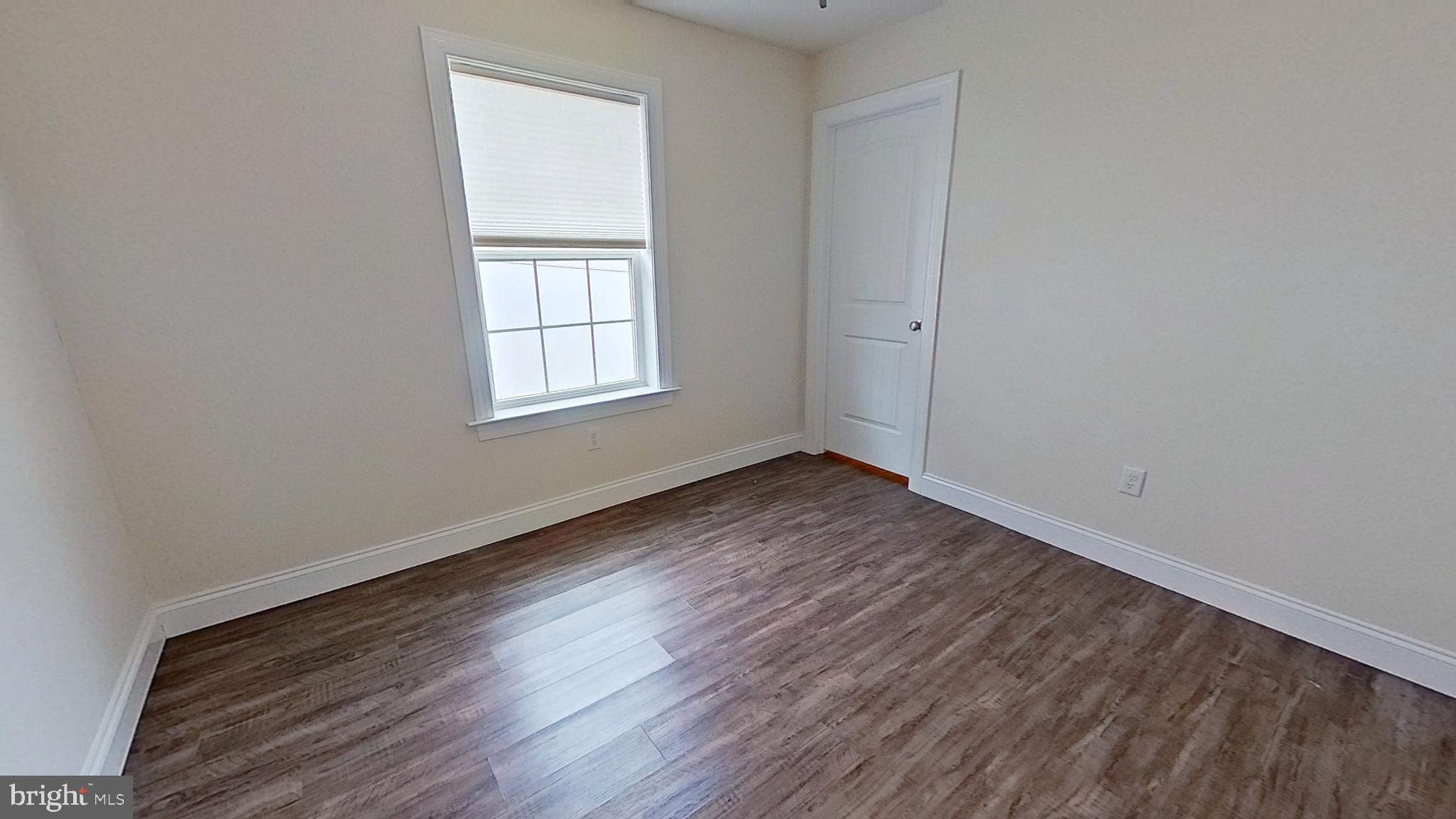 10 Evan Drive York, PA 17404 - Photo 6 of 11 an empty room with wooden floor and windows